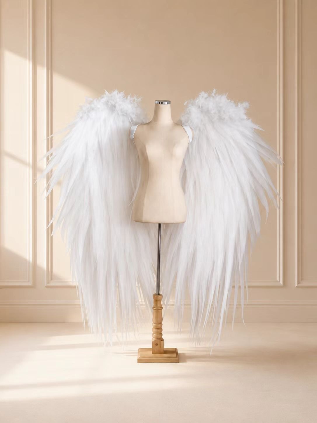 Compact white feather cosplay wings displayed on a dress form.