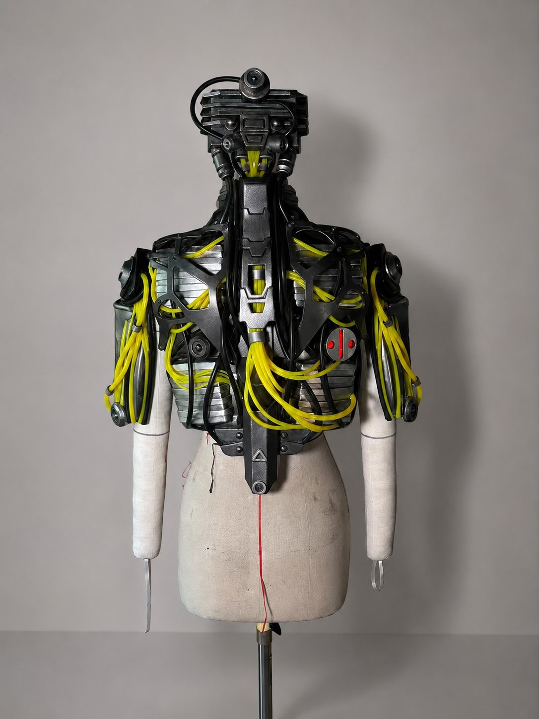 Cyberpunk 2077 Song So Mi Songbird inspired back armor prop set with black EVA armor plates and yellow tube details on a mannequin.