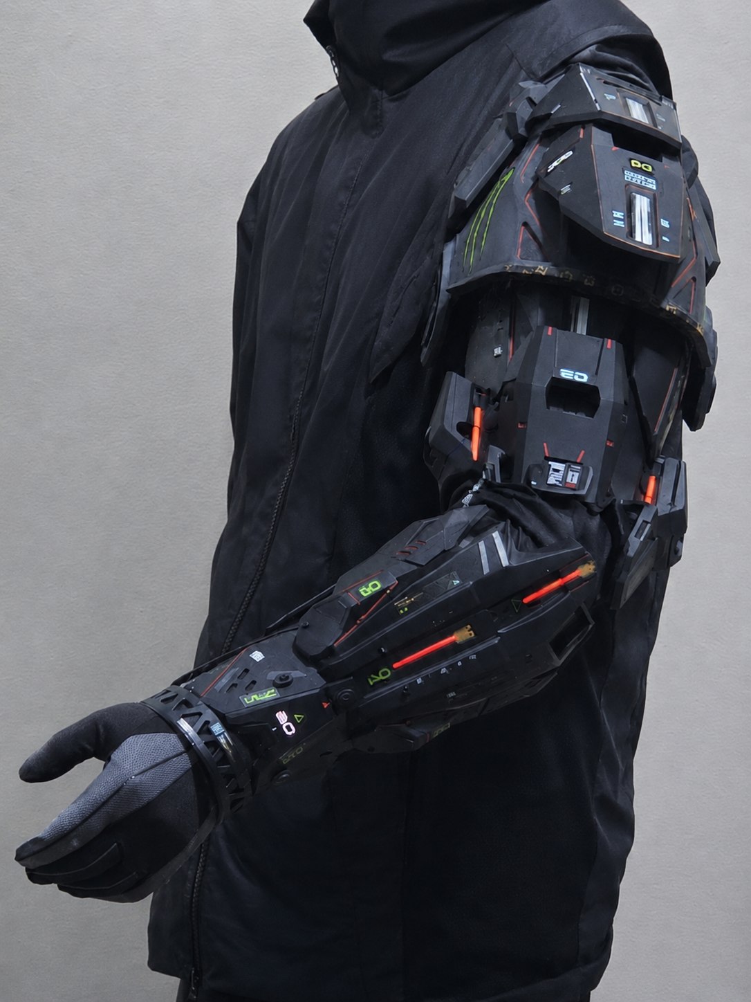 Cyberpunk mechanical prosthetic arm armor with black sci-fi panels, shoulder armor, forearm bracer, and red light details.