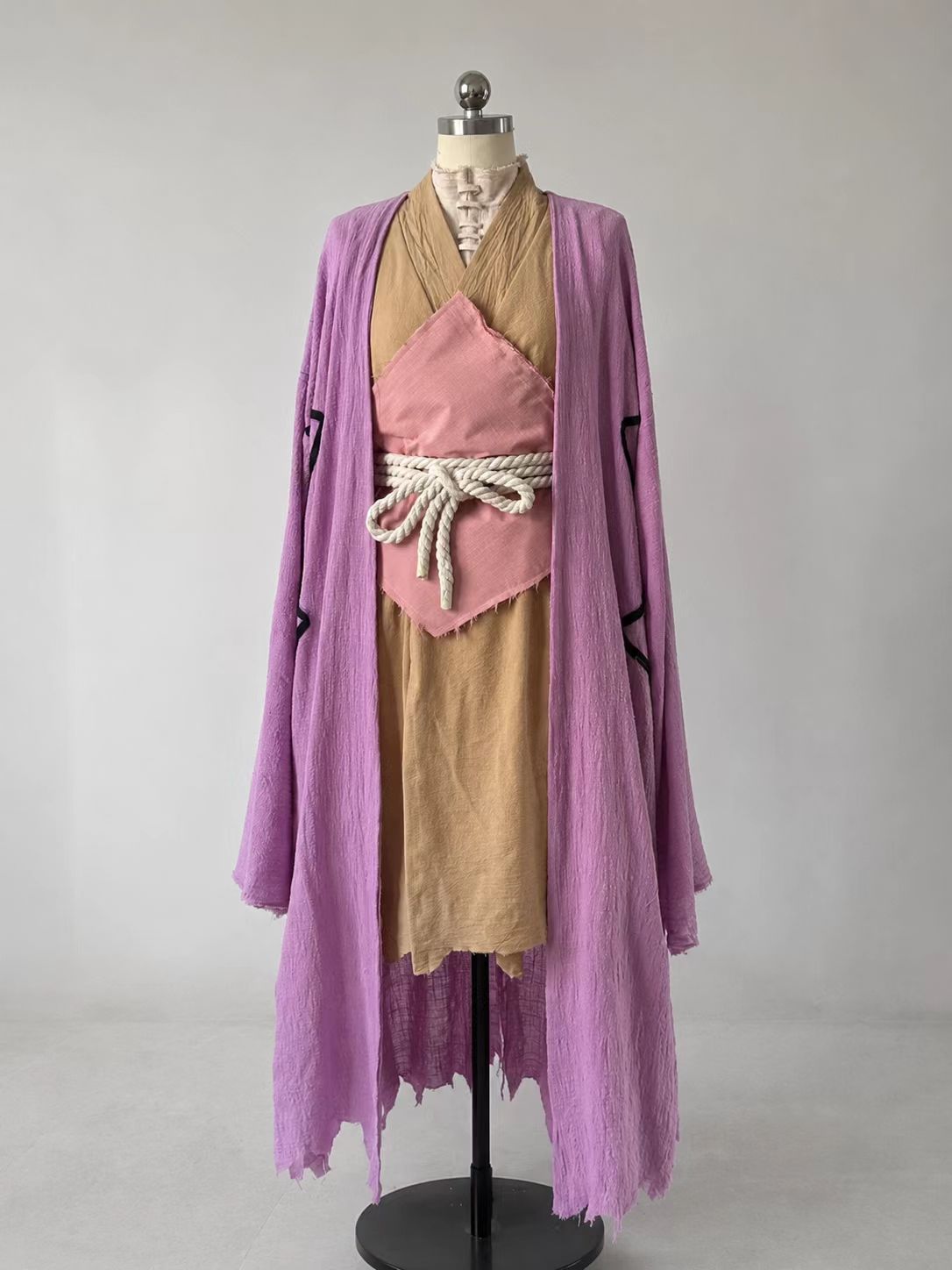 Gen Asagiri Dr. Stone cosplay costume with purple outer robe, khaki inner layer, beige high-neck top, stacked pants, hemp-rope waist tie, and pink waist panel.