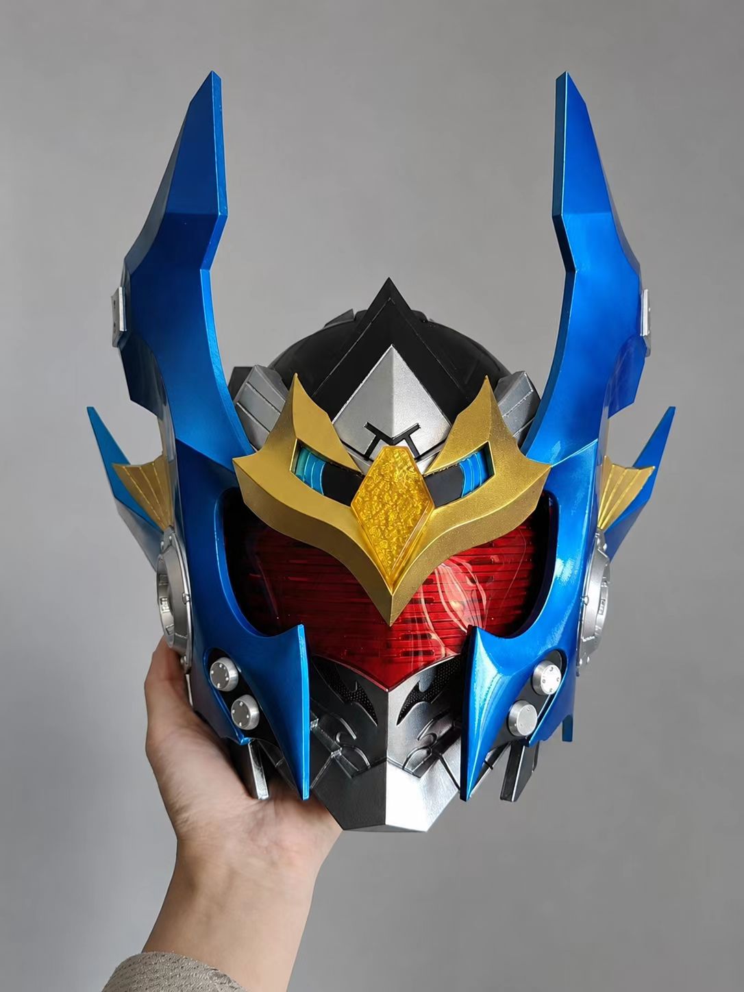Close-up of a blue and gold custom cosplay helmet finish.