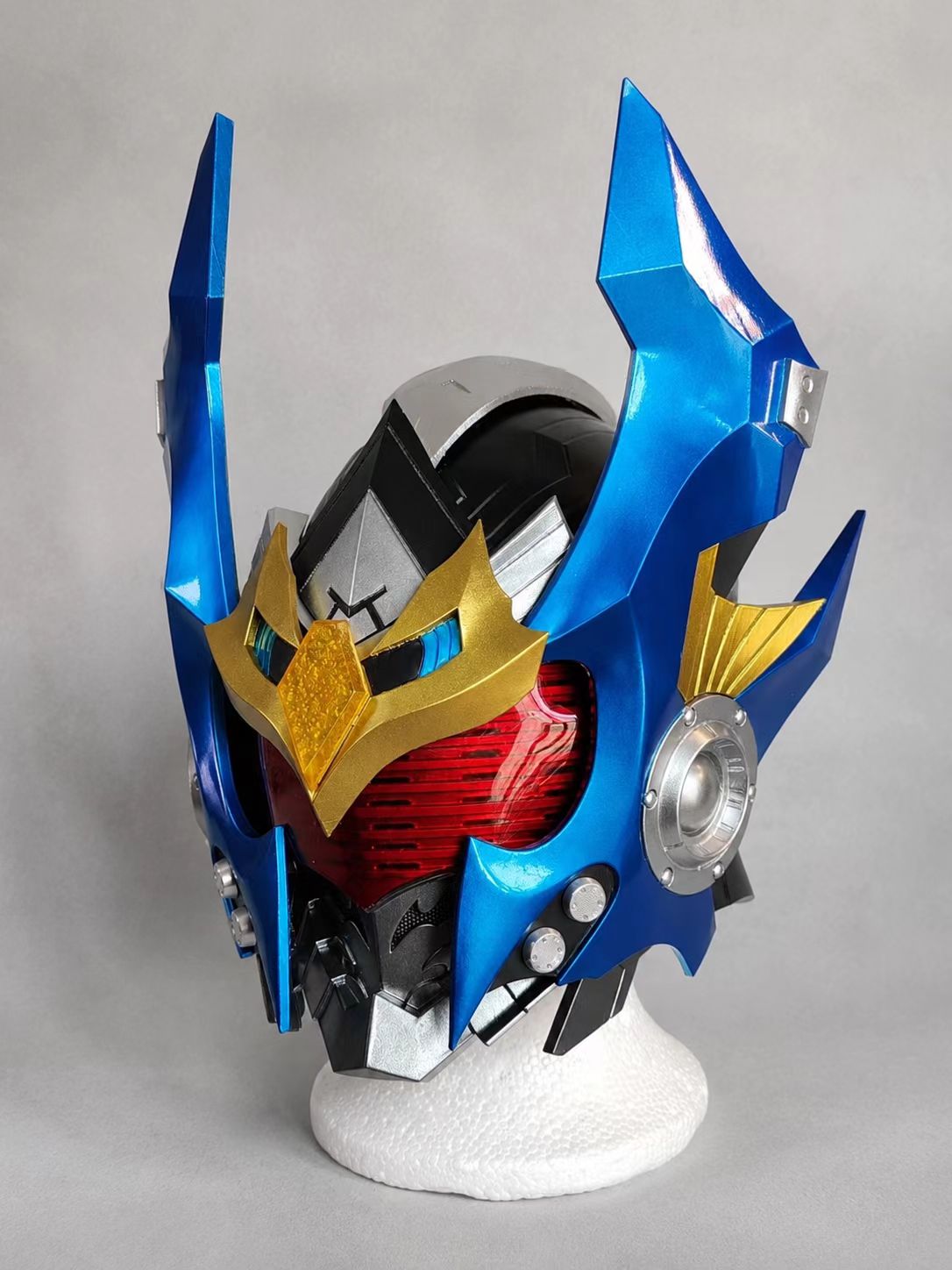 Custom blue and gold EVA cosplay helmet and visor with painted armor finish.