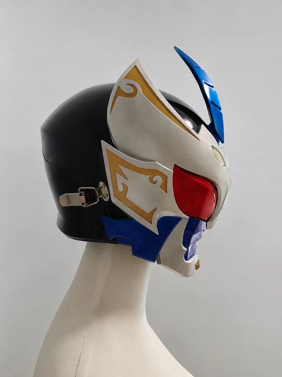 Blue and green custom cosplay visor piece shown handheld.