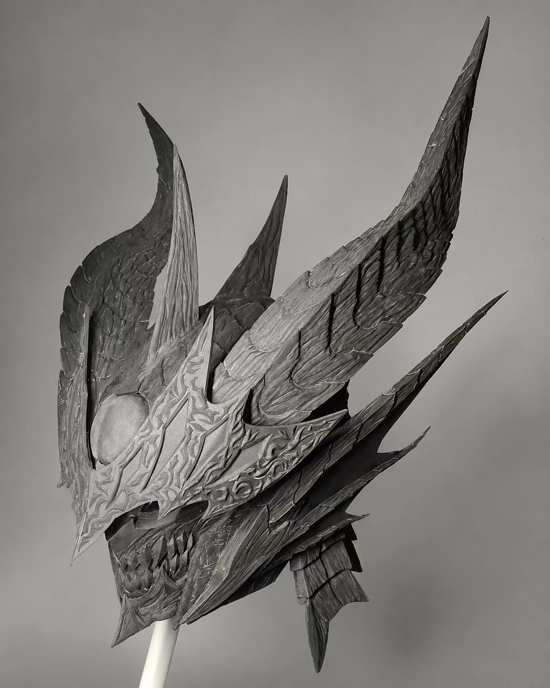 Gold and red cosplay helmet side view with shaped volume.