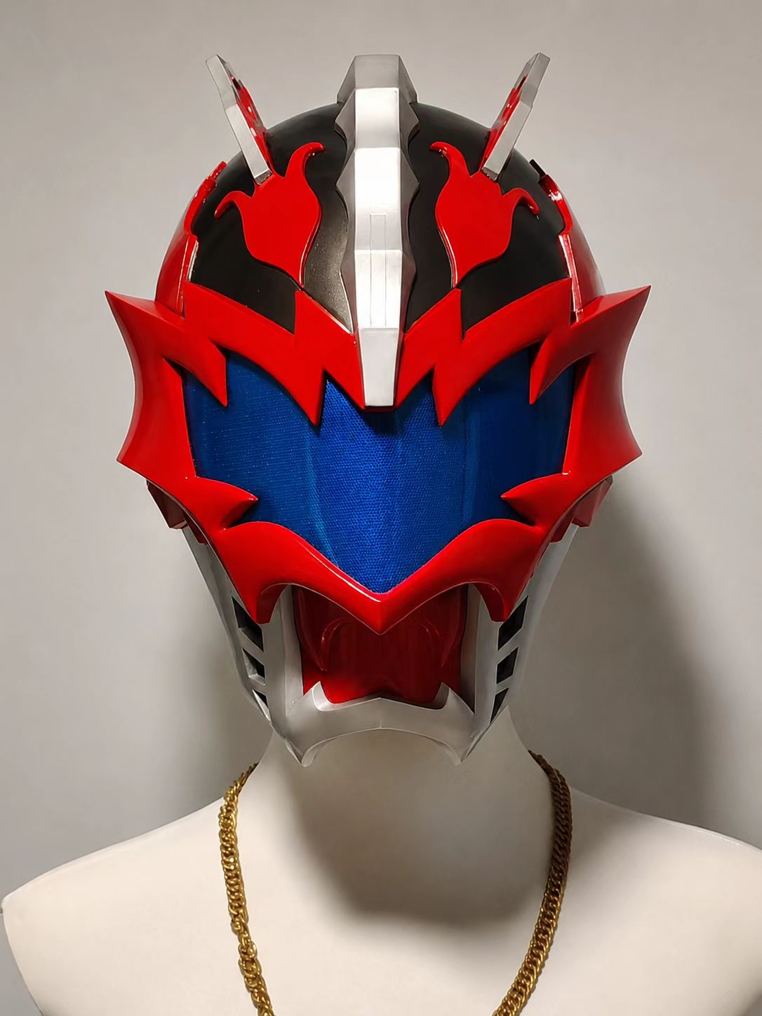 Red and blue cosplay helmet shown from an angled display view.