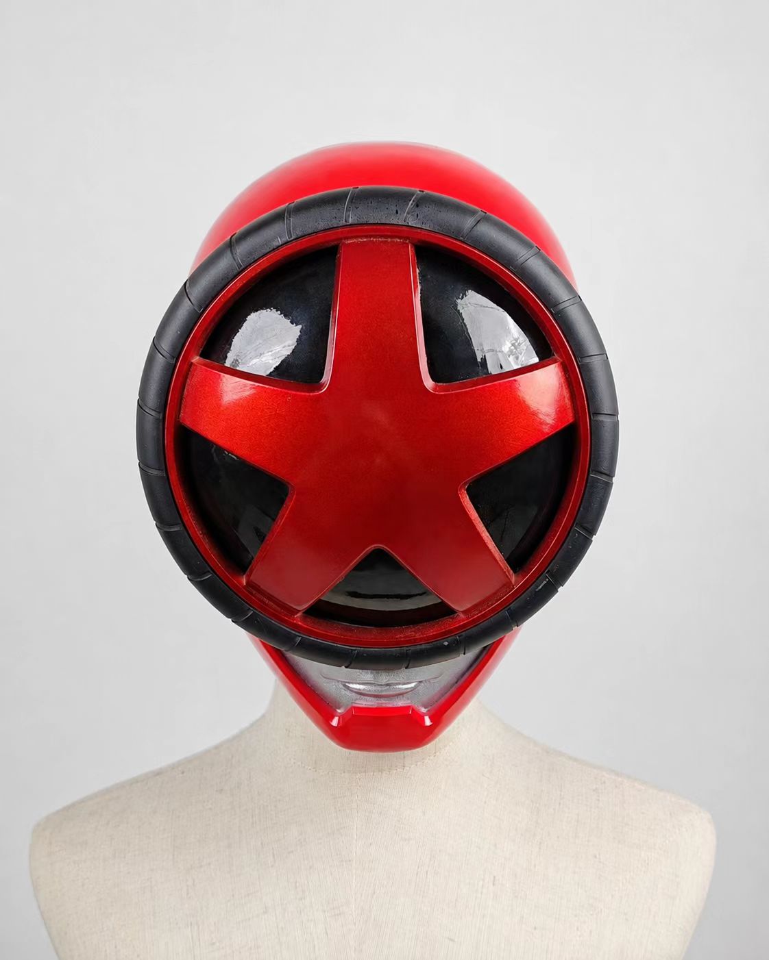 Round red custom cosplay visor displayed against a light background.