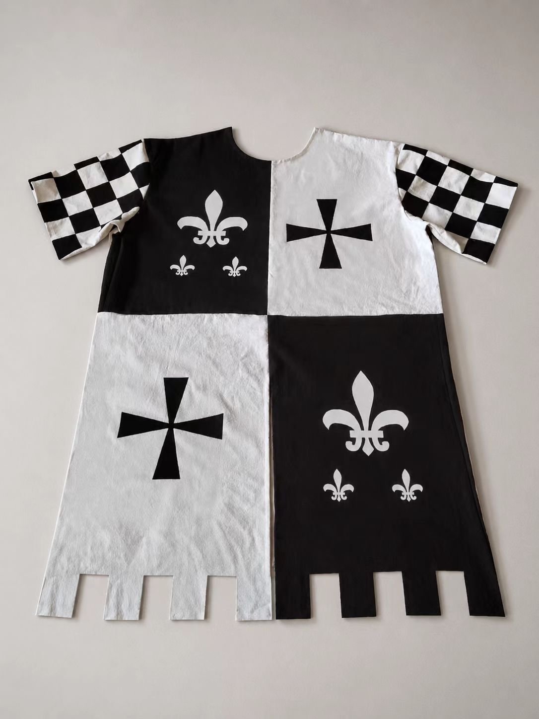 Black and white medieval cosplay tabard with checker sleeve panel.