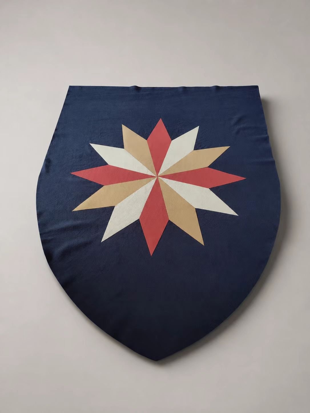 Blue medieval cosplay shield-shaped textile panel with red and white star motif.