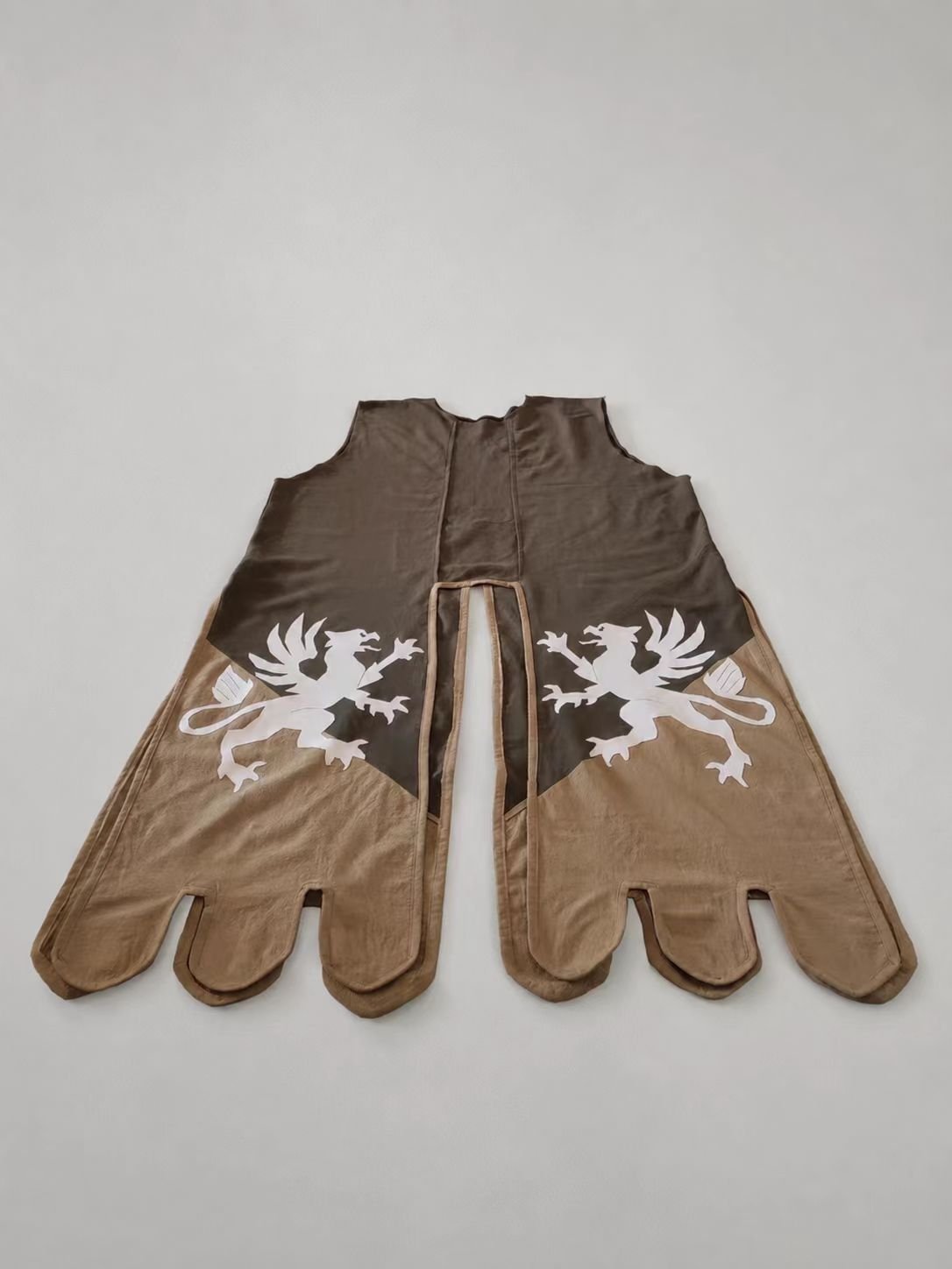 Brown medieval cosplay glove pair with white lions rampant.