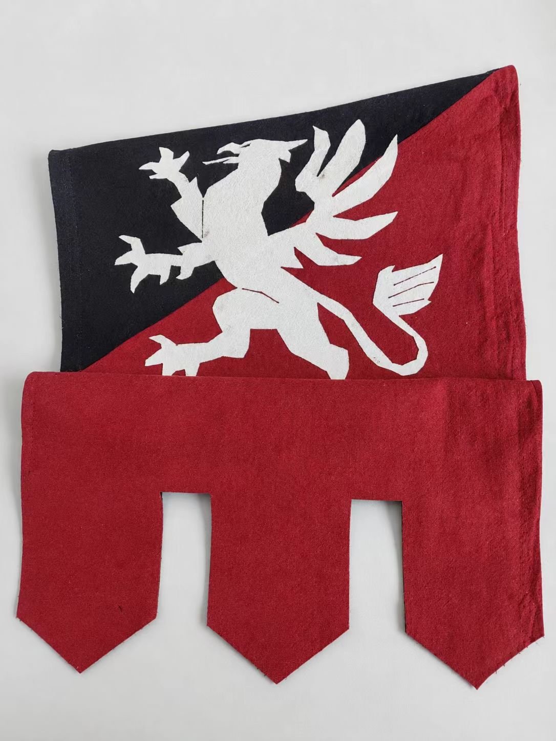 Red and black medieval cosplay banner with a white griffin crest.
