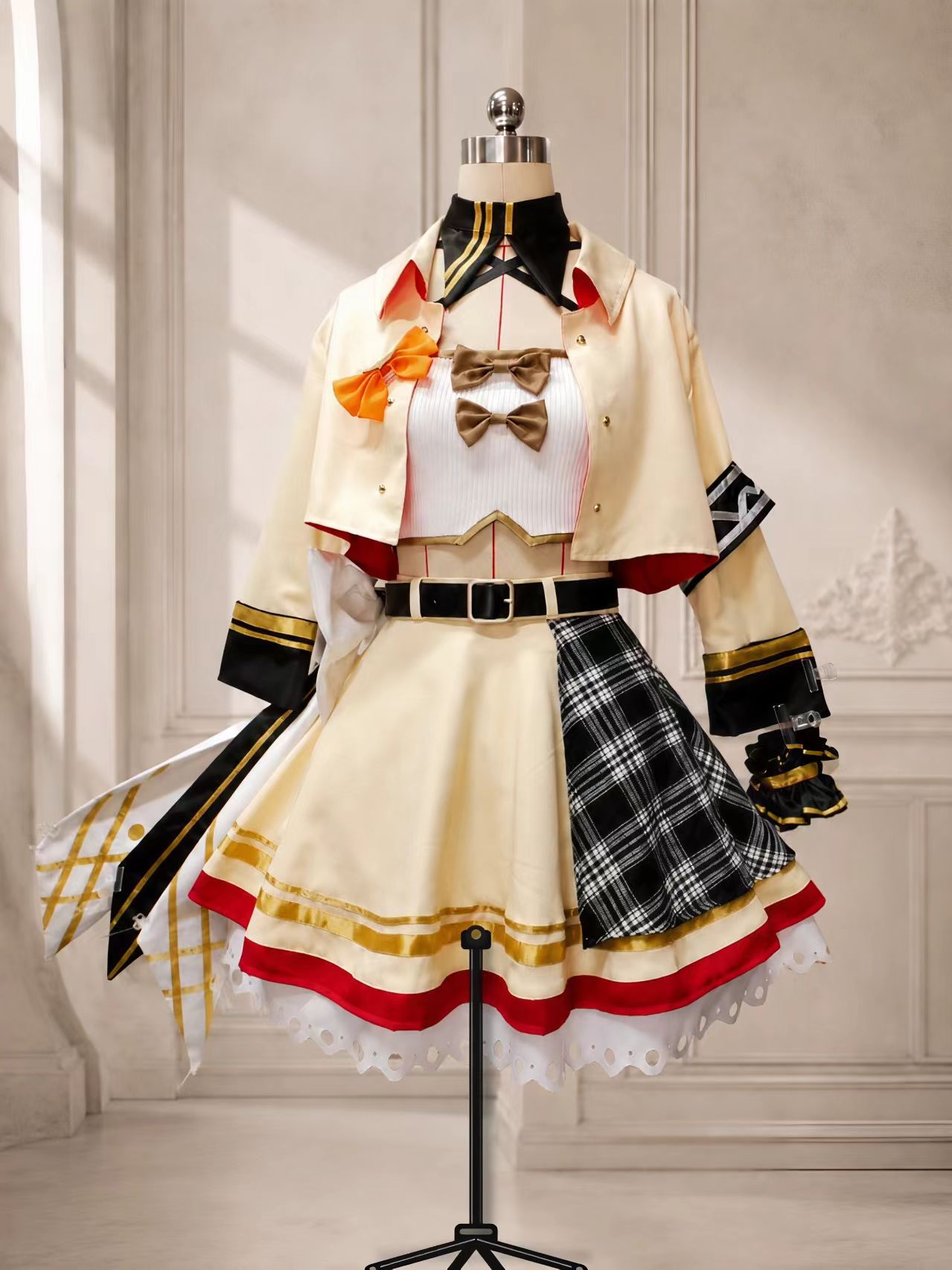 Ran Paterson VTuber cosplay costume set with cream skirt, black plaid panel, cropped jacket, bows, belt, collar, and gold trim.