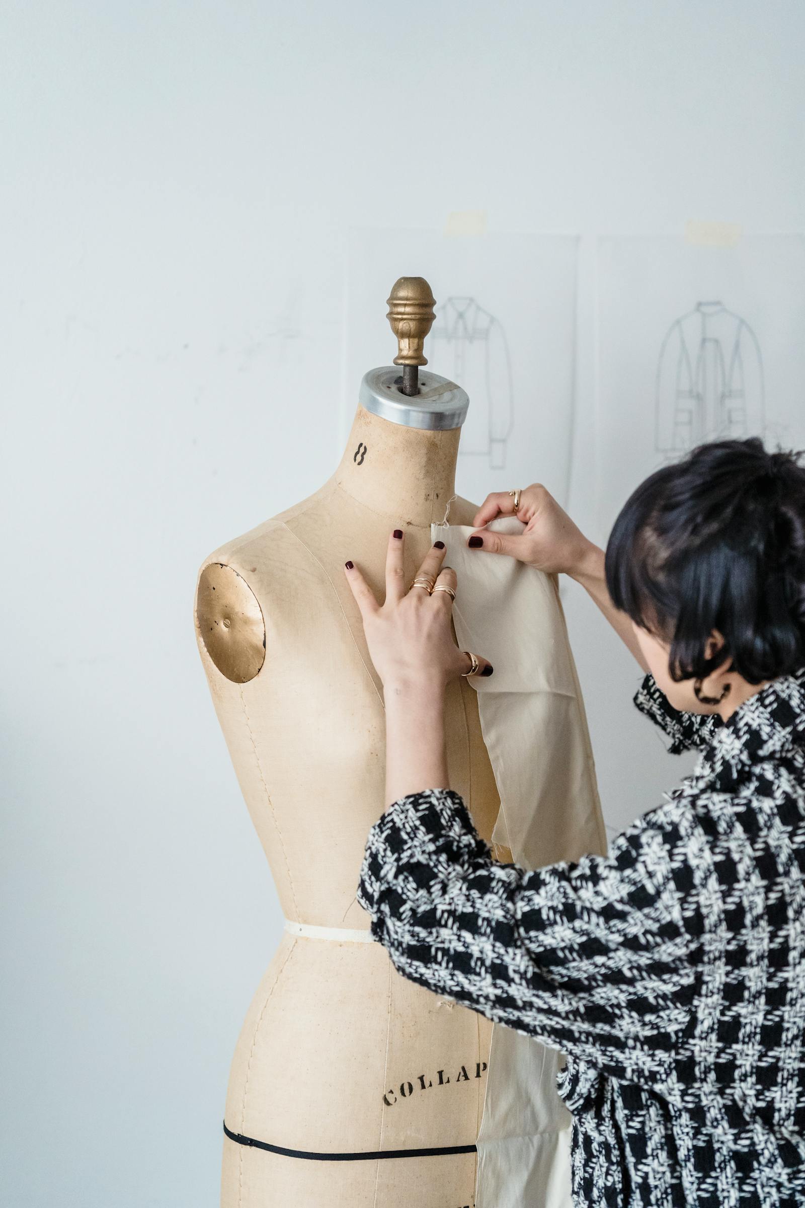Fabric draped on a dress form during fit and silhouette review.