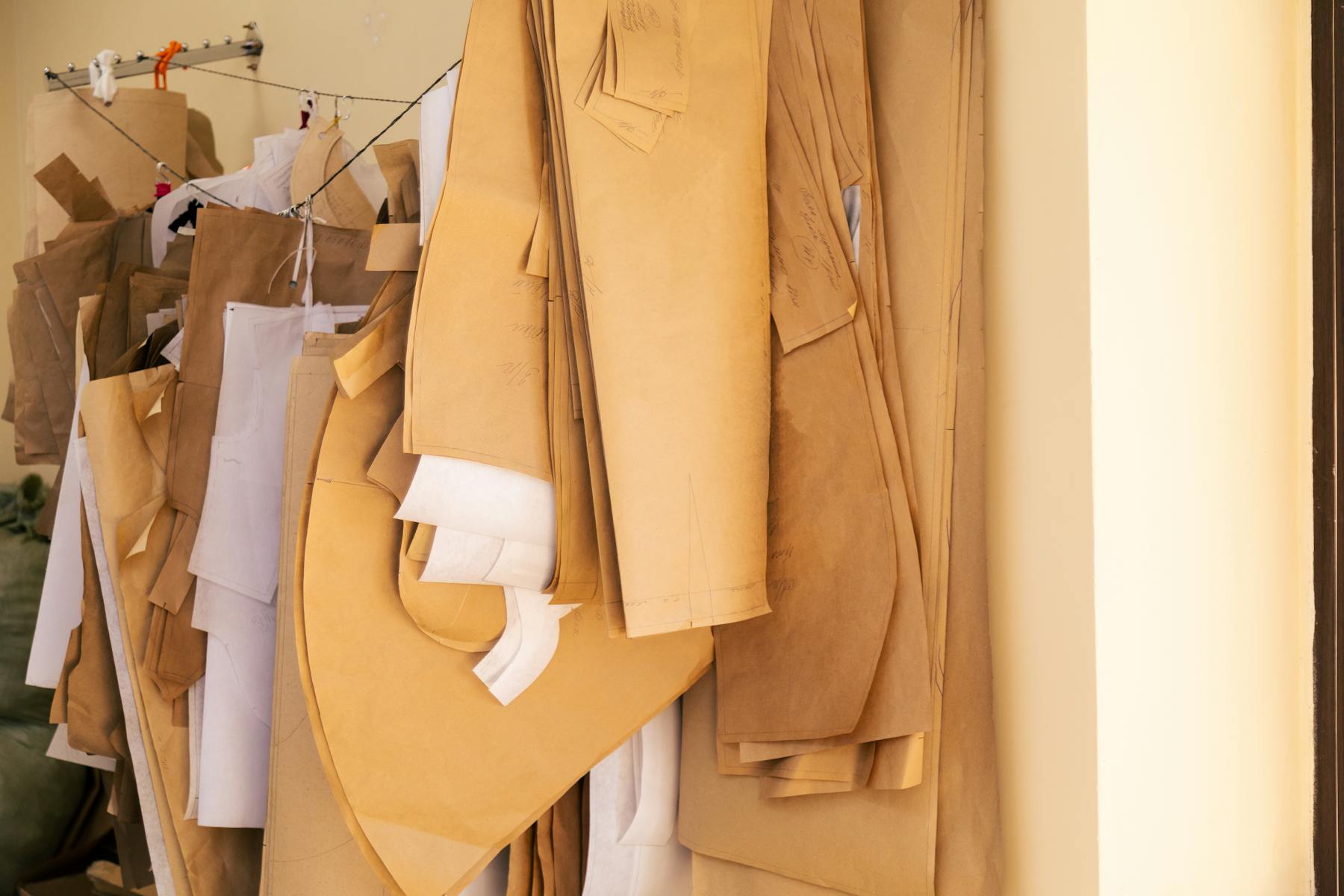 Pattern archive and garment planning references inside a costume atelier.