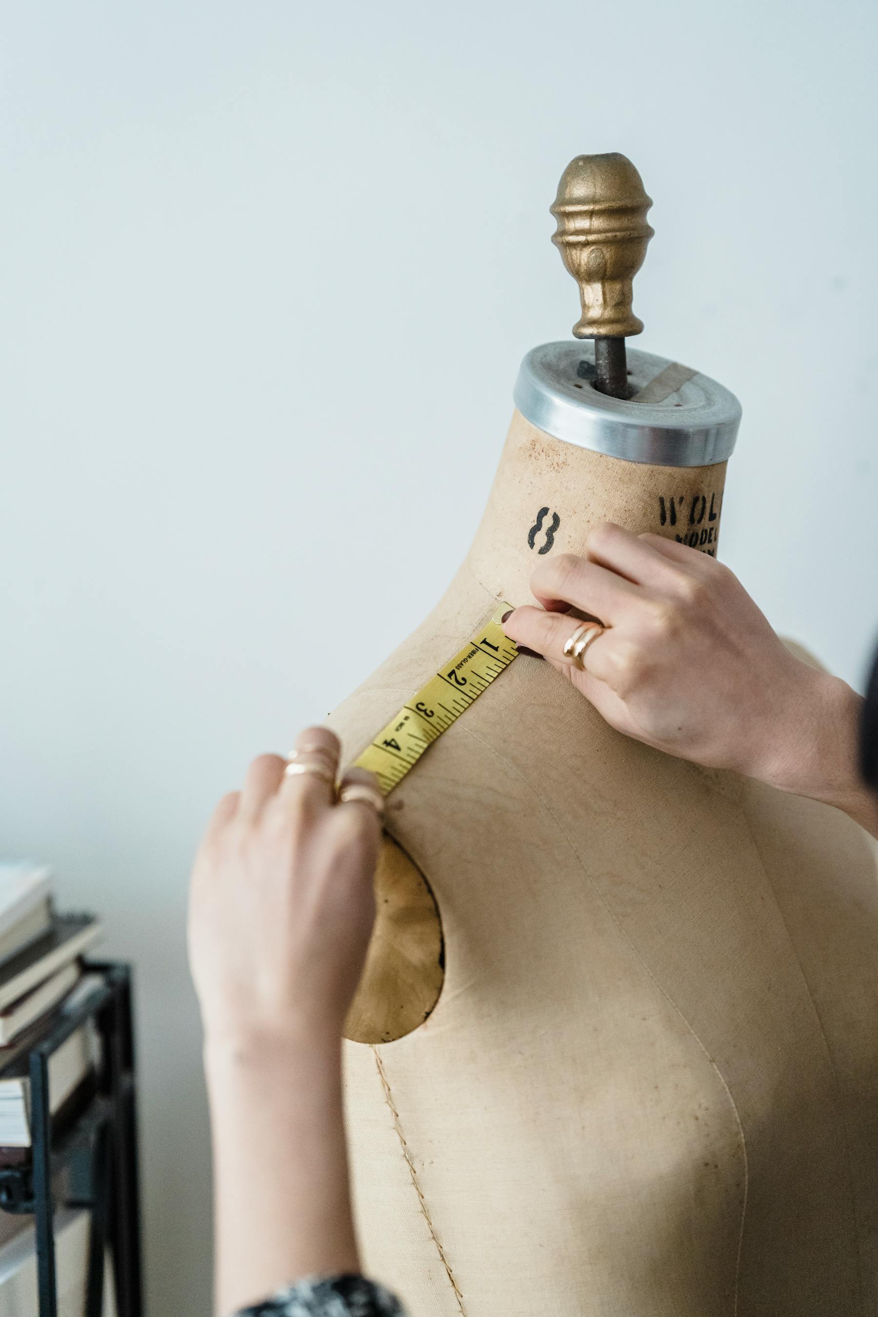 Pattern paper, measurements, and costume planning tools arranged for a custom cosplay quote.
